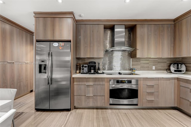 259 E Shore Dr E, Miami, FL 33133 - kitchen featuring appliances with stainless steel finishes, wall chimney range hood, modern cabinets, light brown cabinets, and tasteful backsplash