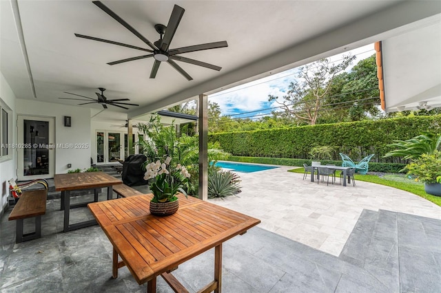 259 E Shore Dr E, Miami, FL 33133 - fenced backyard with outdoor dining space, a ceiling fan, and a patio area