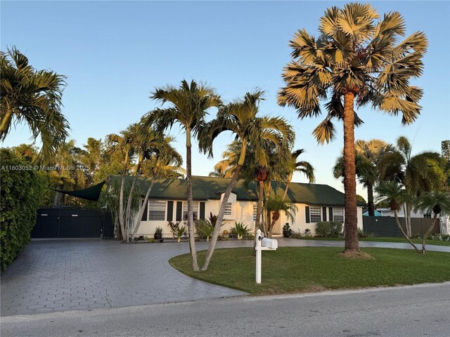 15223 SW 152nd Ave, Miami, FL 33187 - single story home featuring curved driveway, stucco siding, and a gate