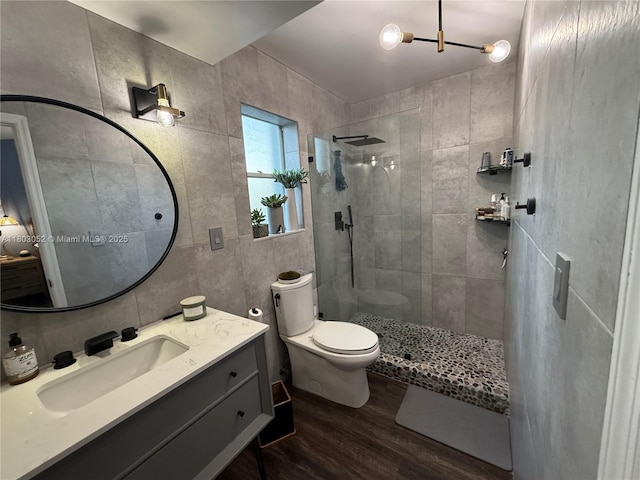15223 SW 152nd Ave, Miami, FL 33187 - bathroom featuring wood finished floors, a walk in shower, toilet, vanity, and tile walls