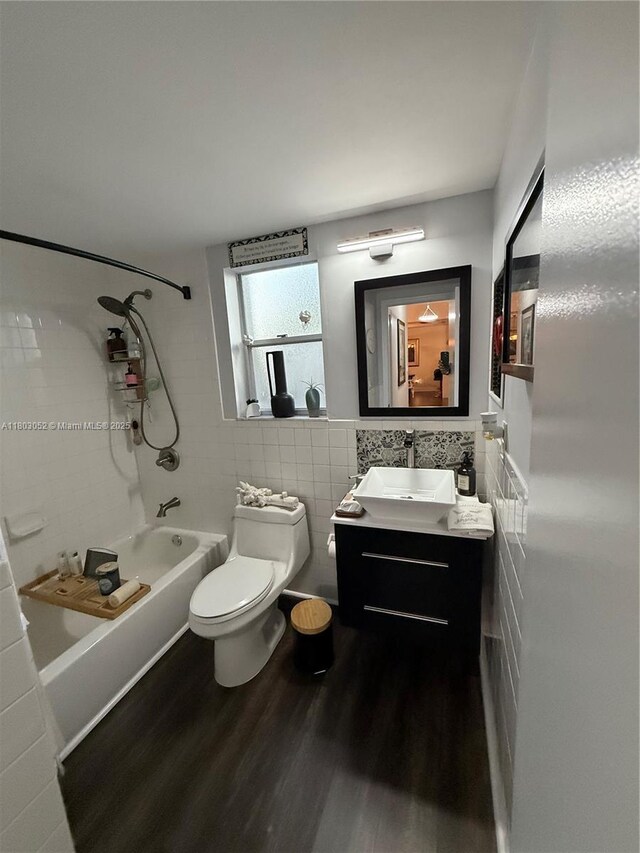 15223 SW 152nd Ave, Miami, FL 33187 - full bathroom with tile walls, tub / shower combination, vanity, toilet, and wood finished floors