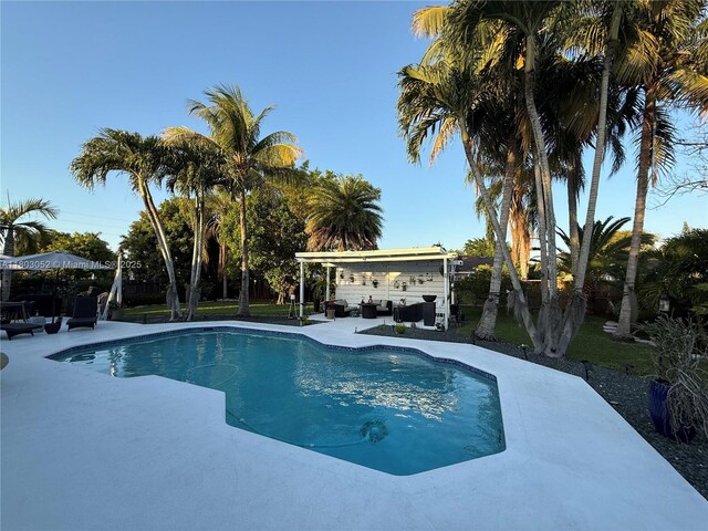 15223 SW 152nd Ave, Miami, FL 33187 - outdoor pool featuring an outdoor hangout area, a patio, and a fenced backyard