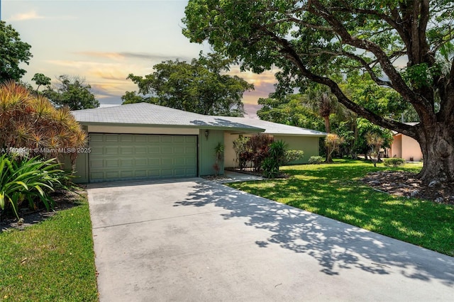 2394 NW 7th Ct, Delray Beach, FL 33445 - view of front of house featuring driveway, a front yard, a garage, and stucco siding