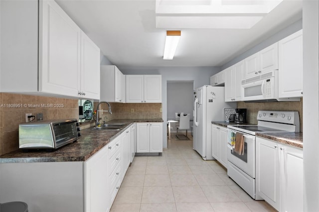 2394 NW 7th Ct, Delray Beach, FL 33445 - kitchen with white appliances, a sink, white cabinetry, and decorative backsplash