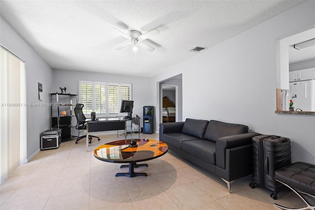 2394 NW 7th Ct, Delray Beach, FL 33445 - living area with a desk, ceiling fan, a textured ceiling, and light tile patterned floors