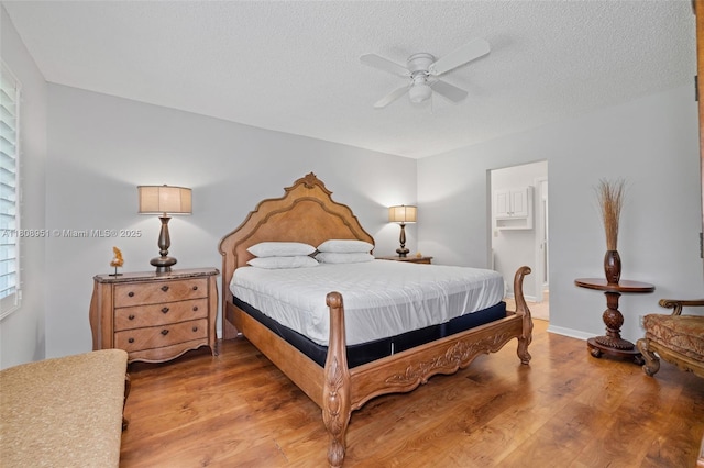 2394 NW 7th Ct, Delray Beach, FL 33445 - bedroom featuring light wood-style flooring, a textured ceiling, and ceiling fan