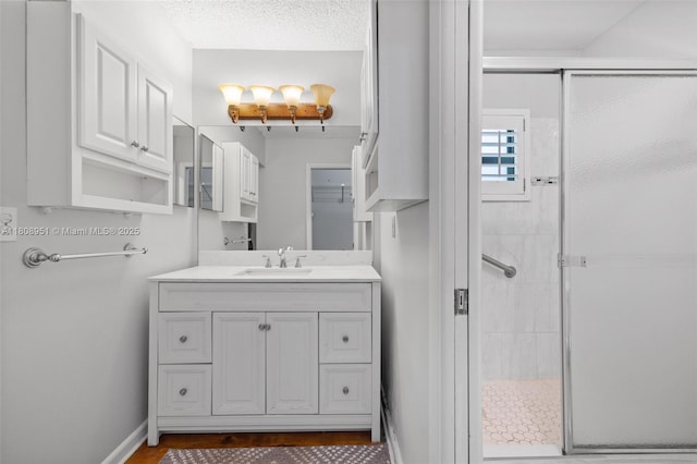 2394 NW 7th Ct, Delray Beach, FL 33445 - full bathroom with a shower stall, vanity, baseboards, and wood finished floors