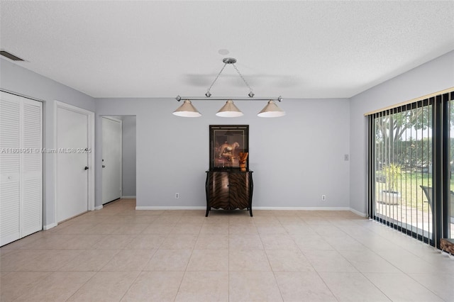 2394 NW 7th Ct, Delray Beach, FL 33445 - spare room with track lighting, baseboards, a textured ceiling, and light tile patterned flooring