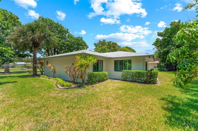 2394 NW 7th Ct, Delray Beach, FL 33445 - view of property exterior with a lawn and stucco siding