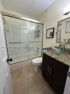 5710 NW 73rd Ave, Tamarac, FL 33321 - full bath featuring vanity, toilet, bath / shower combo with glass door, and tile patterned floors
