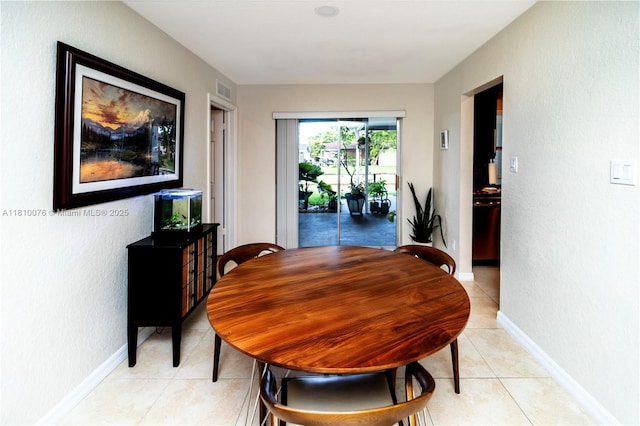5710 NW 73rd Ave, Tamarac, FL 33321 - dining space featuring light tile patterned floors, baseboards, and a textured wall
