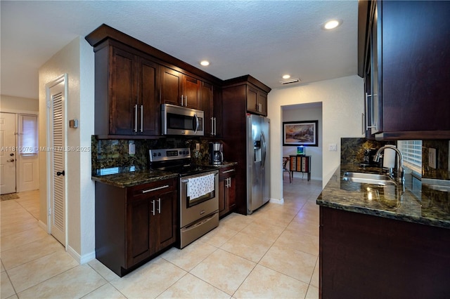 5710 NW 73rd Ave, Tamarac, FL 33321 - kitchen with appliances with stainless steel finishes, a sink, backsplash, dark stone countertops, and recessed lighting