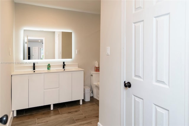 5710 NW 73rd Ave, Tamarac, FL 33321 - bathroom with toilet, double vanity, and wood finished floors