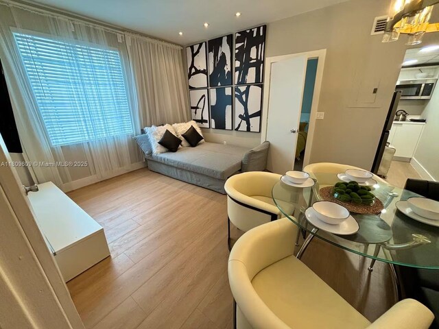 750 Collins Ave Unit 206, Miami Beach, FL 33139 - living area with wood finished floors, recessed lighting, and baseboards