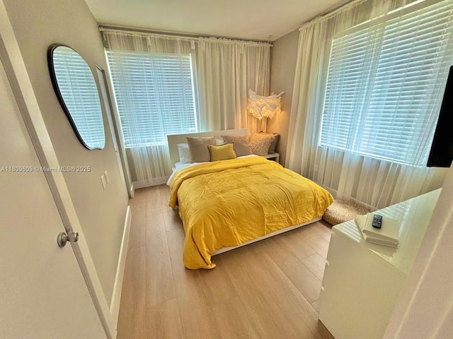 750 Collins Ave Unit 206, Miami Beach, FL 33139 - bedroom featuring wood finished floors and baseboards