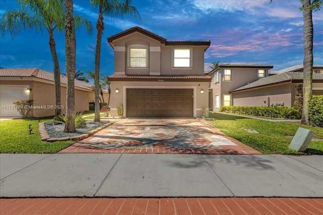 18018 SW 30th Ct, Miramar, FL 33029 - mediterranean / spanish house with stucco siding, a tiled roof, an attached garage, decorative driveway, and a front lawn