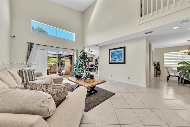 18018 SW 30th Ct, Miramar, FL 33029 - living area featuring a high ceiling, a chandelier, light tile patterned floors, plenty of natural light, and baseboards
