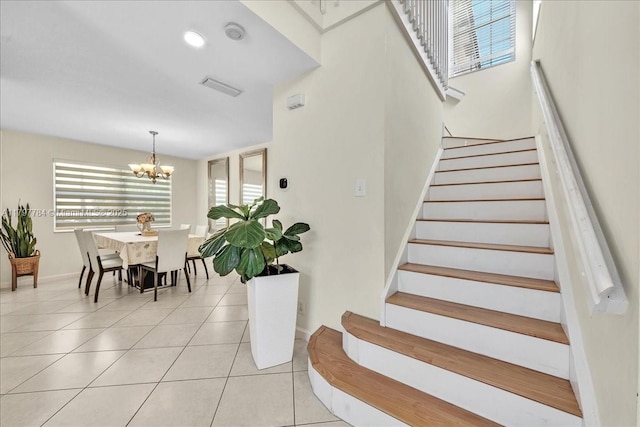 18018 SW 30th Ct, Miramar, FL 33029 - stairs featuring healthy amount of natural light, a chandelier, and tile patterned flooring