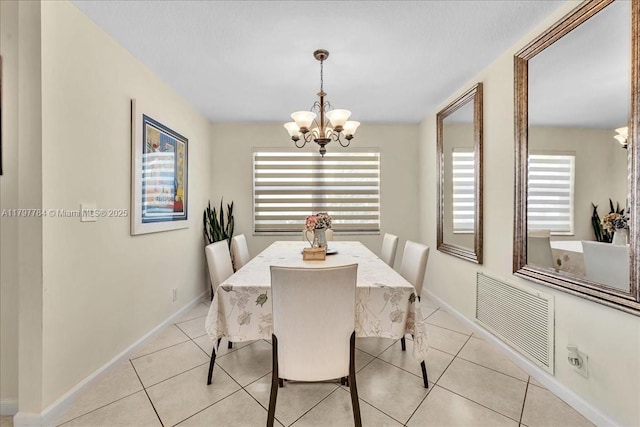 18018 SW 30th Ct, Miramar, FL 33029 - dining space featuring a chandelier, light tile patterned flooring, and baseboards