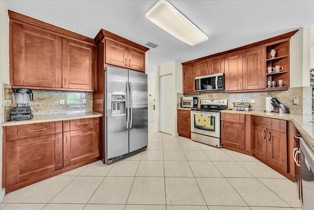 18018 SW 30th Ct, Miramar, FL 33029 - kitchen with appliances with stainless steel finishes, open shelves, decorative backsplash, and light tile patterned floors