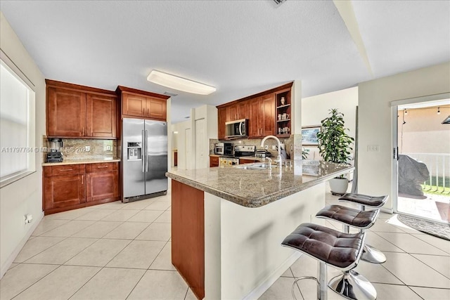 18018 SW 30th Ct, Miramar, FL 33029 - kitchen featuring stainless steel appliances, decorative backsplash, open shelves, and a sink