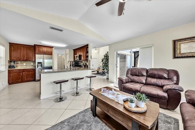 18018 SW 30th Ct, Miramar, FL 33029 - living area featuring light tile patterned flooring, vaulted ceiling, and ceiling fan