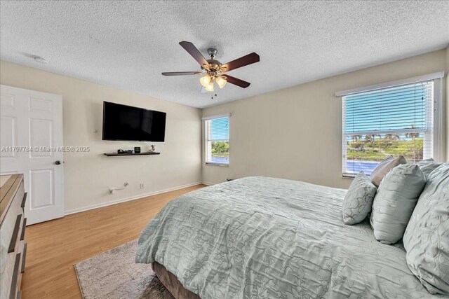 18018 SW 30th Ct, Miramar, FL 33029 - bedroom with light wood-style flooring, a textured ceiling, and ceiling fan