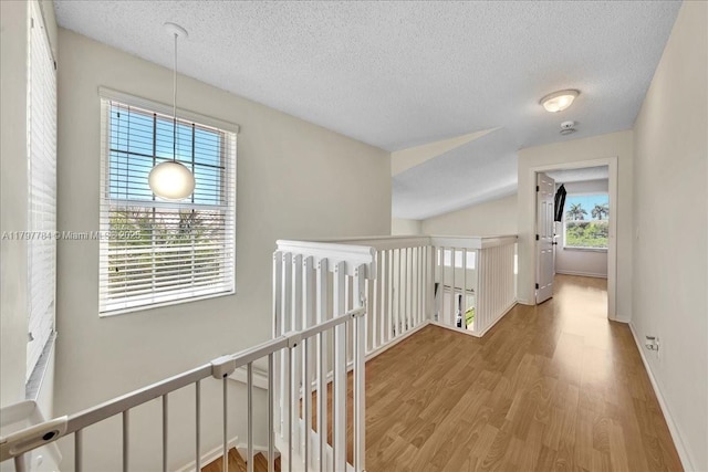 18018 SW 30th Ct, Miramar, FL 33029 - hall with an upstairs landing, wood finished floors, and a textured ceiling