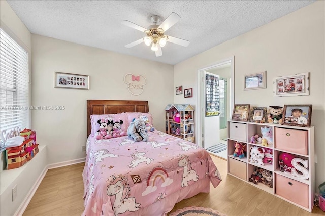 18018 SW 30th Ct, Miramar, FL 33029 - bedroom with wood finished floors, a textured ceiling, ceiling fan, and baseboards