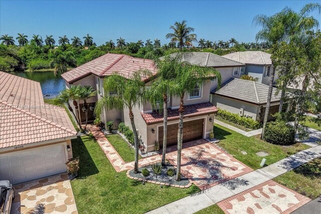 18018 SW 30th Ct, Miramar, FL 33029 - mediterranean / spanish-style house featuring a tiled roof, stucco siding, a front yard, and driveway