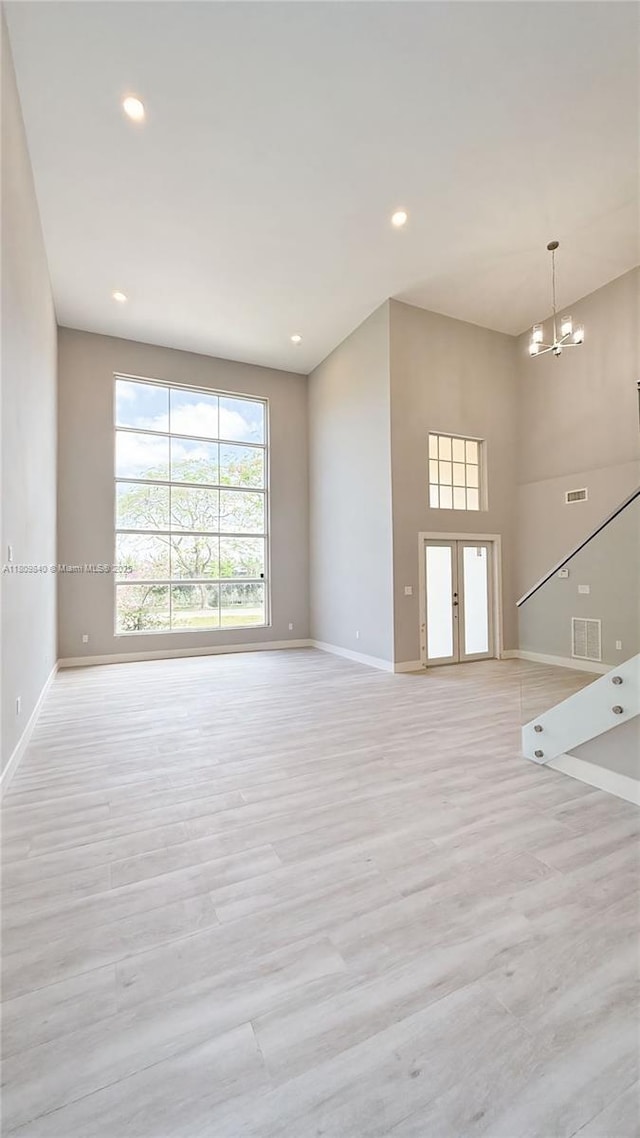 14300 SW 177th Ave, Miami, FL 33196 - unfurnished living room featuring baseboards, light wood-type flooring, a chandelier, and recessed lighting