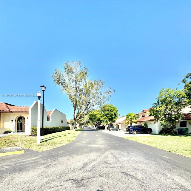 18830 NW 65th Ct, Hialeah, FL 33015 - view of asphalt road with street lighting and a residential view