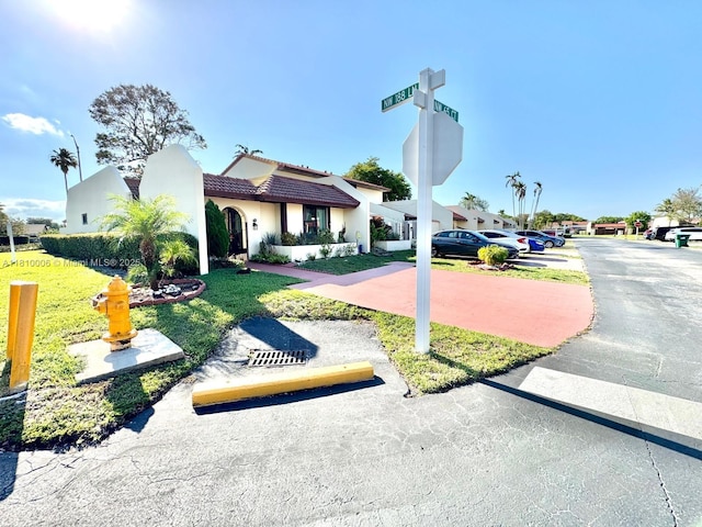 18830 NW 65th Ct, Hialeah, FL 33015 - view of front of home featuring a tile roof, stucco siding, and a front lawn