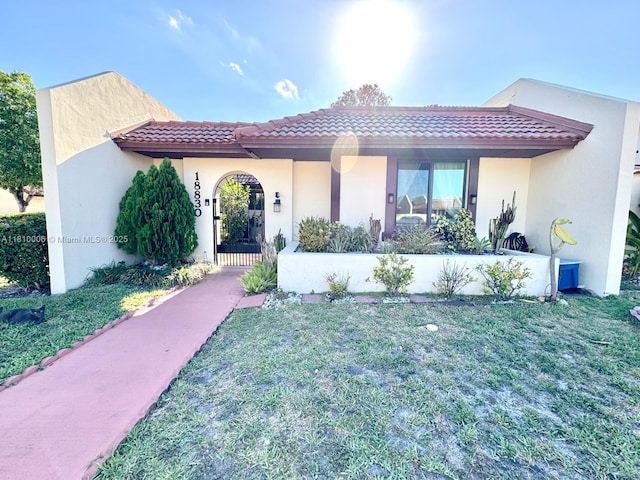 18830 NW 65th Ct, Hialeah, FL 33015 - mediterranean / spanish-style house with a tile roof, a front lawn, and stucco siding