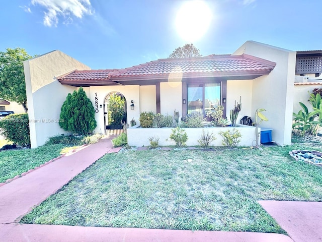 18830 NW 65th Ct, Hialeah, FL 33015 - mediterranean / spanish-style house featuring a tiled roof, stucco siding, and a front lawn