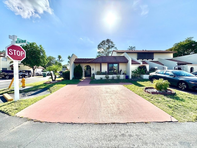 18830 NW 65th Ct, Hialeah, FL 33015 - view of front of property featuring stucco siding, a tile roof, a front lawn, and driveway