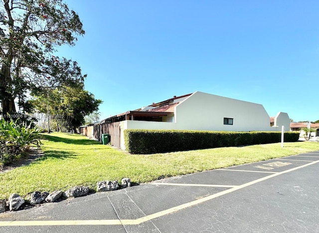 18830 NW 65th Ct, Hialeah, FL 33015 - view of side of property featuring a lawn and stucco siding