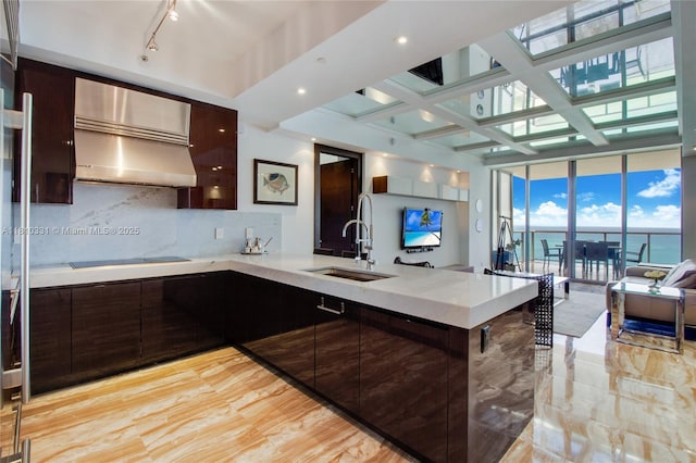 9703 Collins Ave Unit 2615, Bal Harbour, FL 33154 - kitchen with a sink, modern cabinets, light countertops, a peninsula, and coffered ceiling