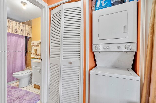 5829 Taylor St, Hollywood, FL 33021 - laundry area featuring stacked washer / dryer and tile patterned floors