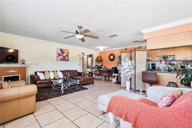 5829 Taylor St, Hollywood, FL 33021 - living room featuring ceiling fan, light tile patterned floors, ornamental molding, and a textured ceiling