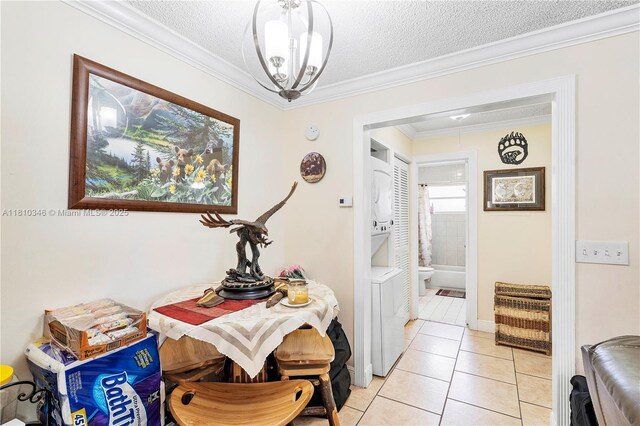 5829 Taylor St, Hollywood, FL 33021 - corridor with stacked washing machine and dryer, light tile patterned floors, a textured ceiling, ornamental molding, and a chandelier