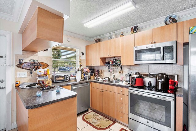 5829 Taylor St, Hollywood, FL 33021 - kitchen with stainless steel appliances, crown molding, a textured ceiling, light brown cabinets, and dark countertops