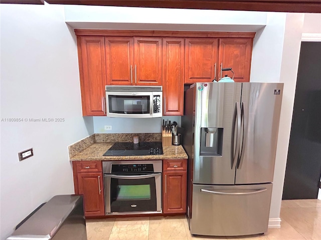 1805 Ponce De Leon Blvd Unit 626, Coral Gables, FL 33134 - kitchen with stainless steel appliances, light stone countertops, and brown cabinets