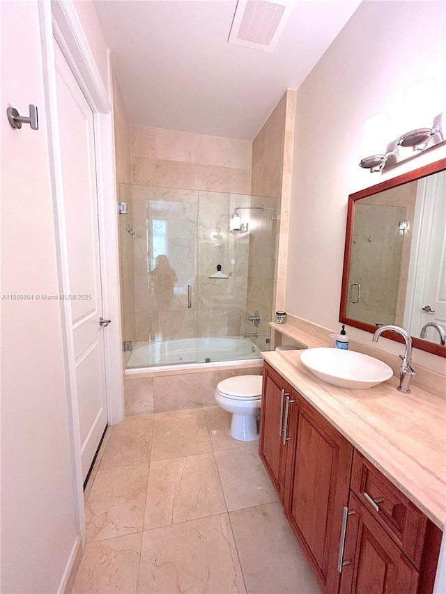 1805 Ponce De Leon Blvd Unit 626, Coral Gables, FL 33134 - bathroom featuring combined bath / shower with glass door, toilet, and vanity