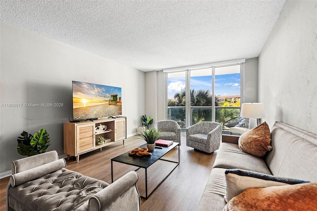 19380 Collins Ave Unit 317, Sunny Isles Beach, FL 33160 - living area featuring a textured ceiling, wood finished floors, and floor to ceiling windows
