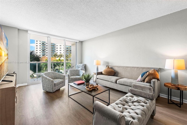 19380 Collins Ave Unit 317, Sunny Isles Beach, FL 33160 - living room with wood finished floors, expansive windows, a textured ceiling, and baseboards