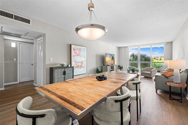 19380 Collins Ave Unit 317, Sunny Isles Beach, FL 33160 - dining area with wood finished floors, a textured ceiling, and baseboards