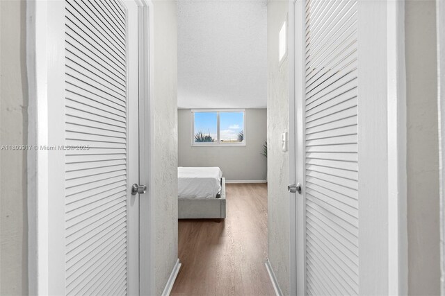19380 Collins Ave Unit 317, Sunny Isles Beach, FL 33160 - corridor featuring wood finished floors and baseboards