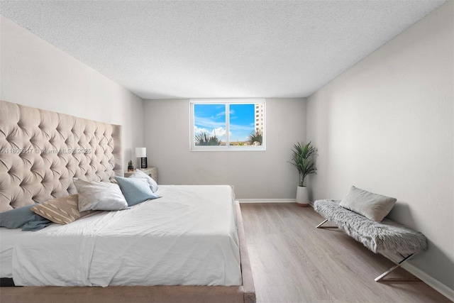 19380 Collins Ave Unit 317, Sunny Isles Beach, FL 33160 - bedroom with wood finished floors, a textured ceiling, and baseboards