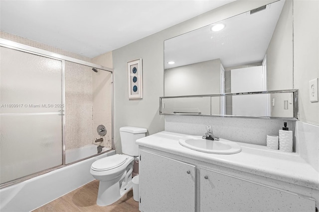 19380 Collins Ave Unit 317, Sunny Isles Beach, FL 33160 - full bath featuring toilet, vanity, combined bath / shower with glass door, and wood finished floors